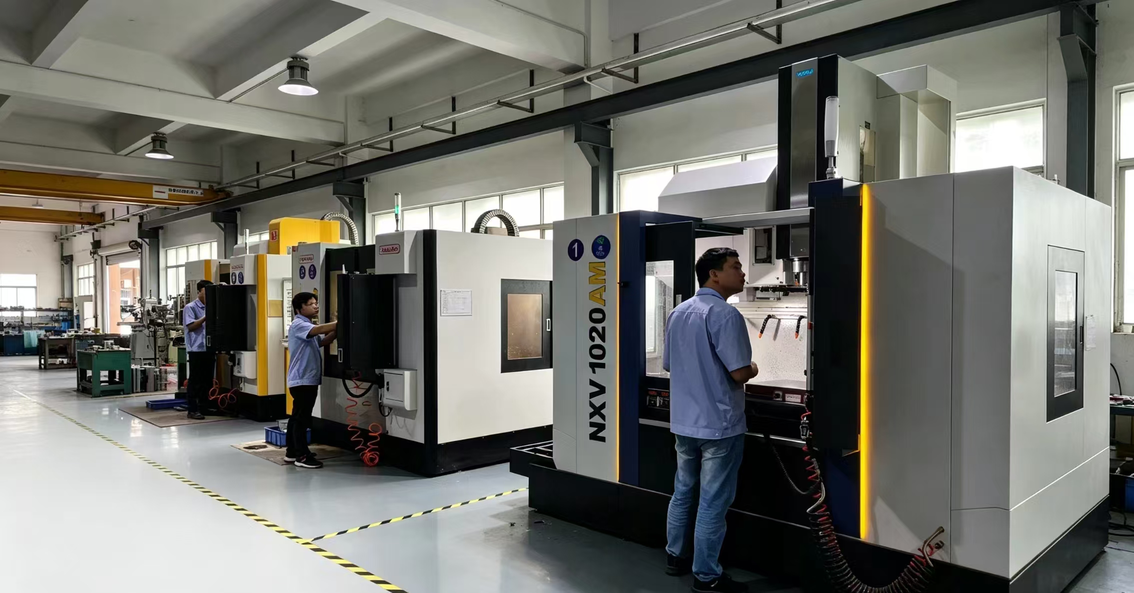 Dongguan manufacturing workshop, workers operate CNC injection‑molding machines for PSA card holders and custom phone cases wholesale production